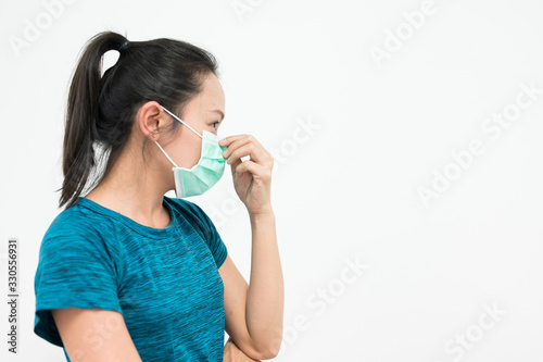 Portrait Asian woman wearing medical mask .Young girl wearing mouth mask against air smog pollution. Concept of corona virus quarantine or covid-19.Protection against virus and infection control.