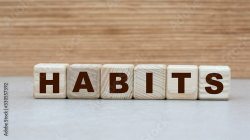 concept of the word habits on cubes on a wooden background photo