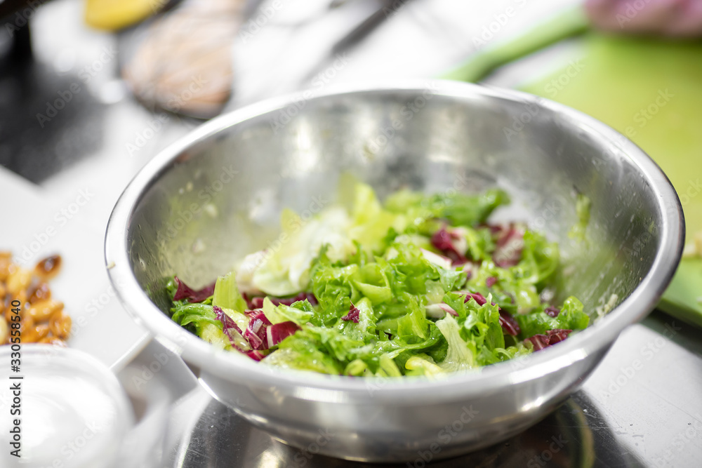 Vegetable salad green with dressing olive oil in steel plate Vegetable salad green with dressing olive oil in steel plate