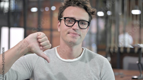 Portrait Shoot of Handsome Guy showing Thumbs Down