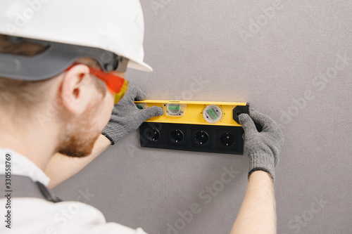 Electrician builder install working switches and sockets black color loft style