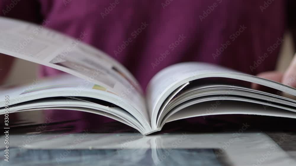 Male Hand Flipping Book Pages During Reading. Close Up shot. Guy Reading Book Male Hand Flipping Book Pages During Reading. Close Up shot. Guy Reading Book
