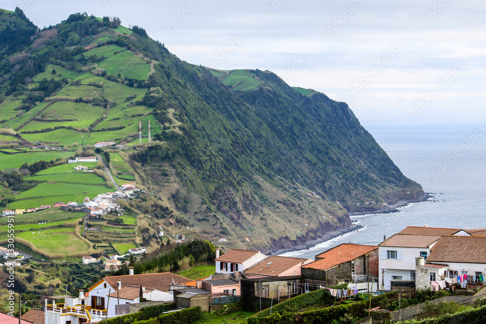 Beautiful coastal village on island with lush green nature