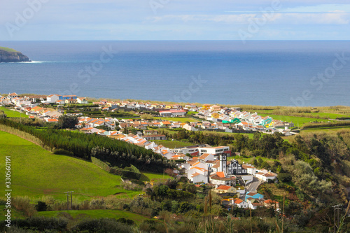 Beautiful coastal village on island with lush green nature