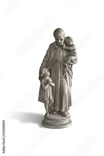 The statue of a saint who is helping children isolated on white background with clipping path
