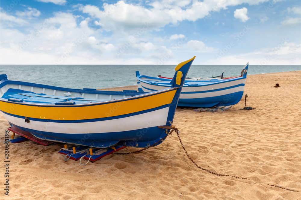 Fishing boats by the sea on a sunny day.