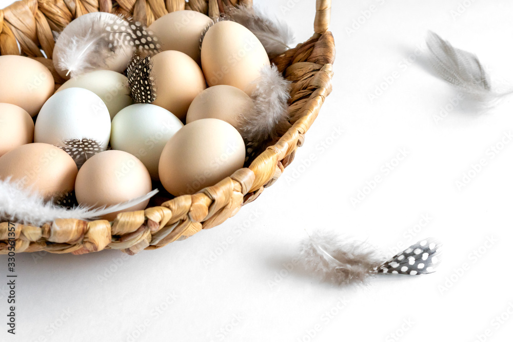 Fresh raw farm organic chiken eggs in a basket on white background Fresh raw farm organic chiken eggs in a basket on white background
