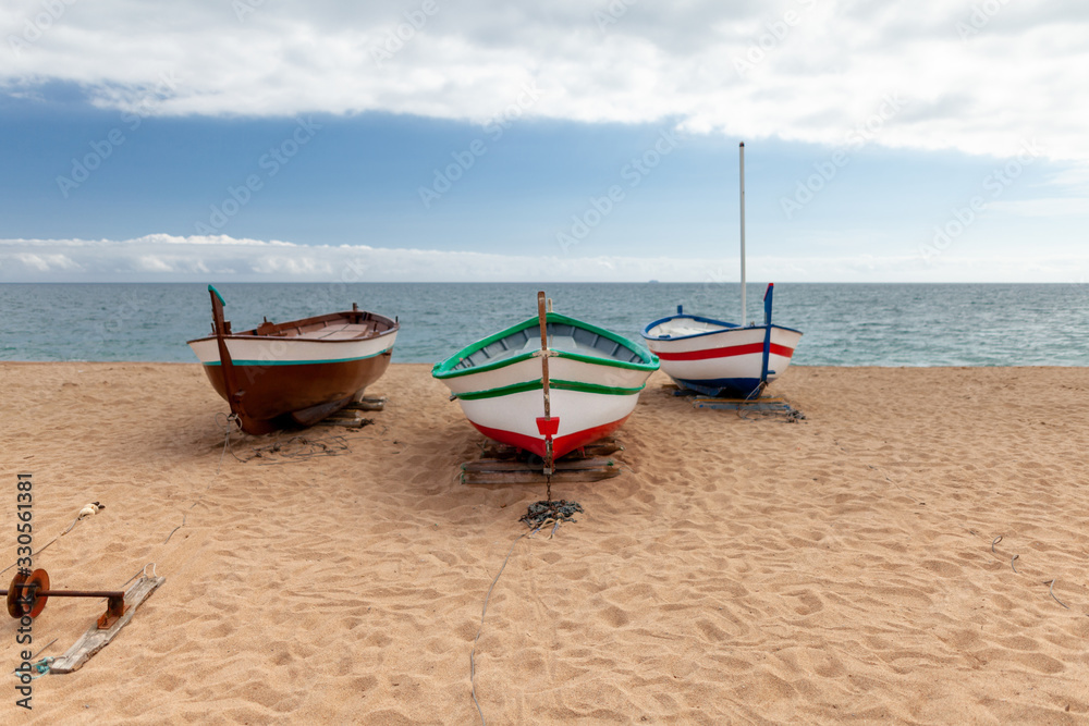 several colorful fishing boats by the sea on a sunny day
