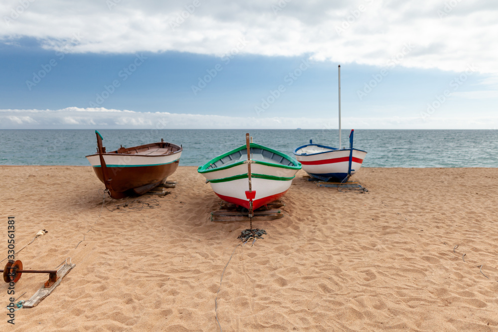 several colorful fishing boats by the sea on a sunny day several colorful fishing boats by the sea on a sunny day