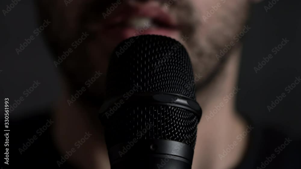 Young bearded Man Talks To Microphone. Man microphone speech, close up front view