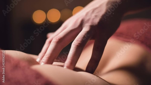 Wallpaper Mural Close-up male hand of a professional physiotherapist masseur doing lumbar massage to a female patient in a massage luxury room with dim light Torontodigital.ca