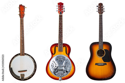 a set of three classic stringed musical instruments a six-string resonator guitar, a six- string acoustic guitar and a six- string banjo isolated on a white background