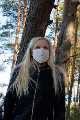 Blonde woman with white face mask, coronavirus, COVID-19