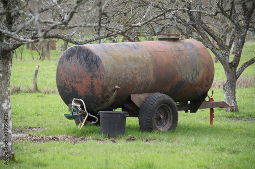 Rusty old meadow water tank for horses