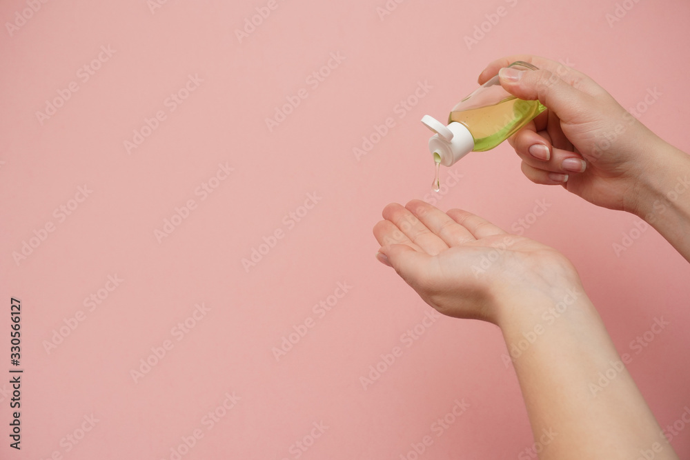Female hands squeezing antibacterial gel. Antiseptic hand gel for hands disinfection and cleaning during flu virus outbreak, coronavirus epidemic and infectious diseases Female hands squeezing antibacterial gel. Antiseptic hand gel for hands disinfection and cleaning during flu virus outbreak, coronavirus epidemic and infectious diseases