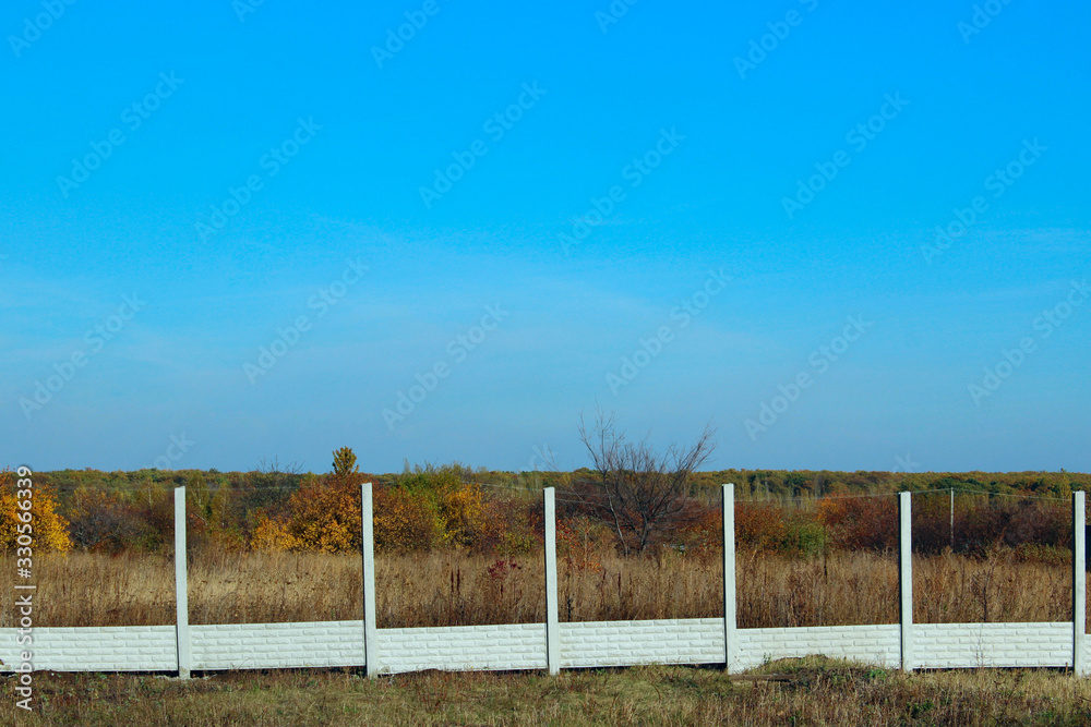 Concrete fence construction. Construction, construction site. Abstract rural background.