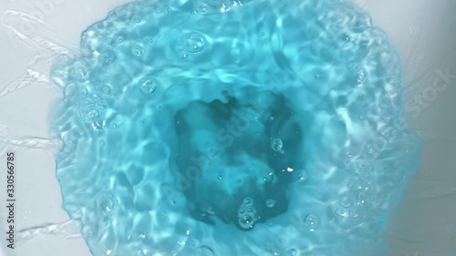 Bluewater is swirling in the toilet flush to clean and water being flushed in a toilet bowl.4k 25fps