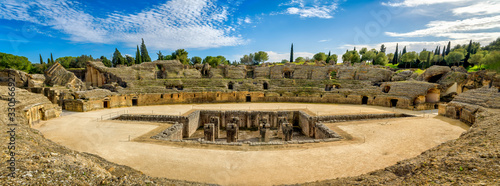 Panoramic view of the Roman amphitheater in the ancient town of Italica in Santiponce, Spain. photo