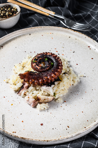 Italian classic Risotto with octopus tentacles. White grey background. Top view