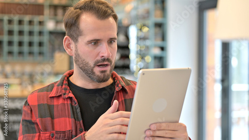 Portrait of Shocked Young Man Using Tablet, Wondering