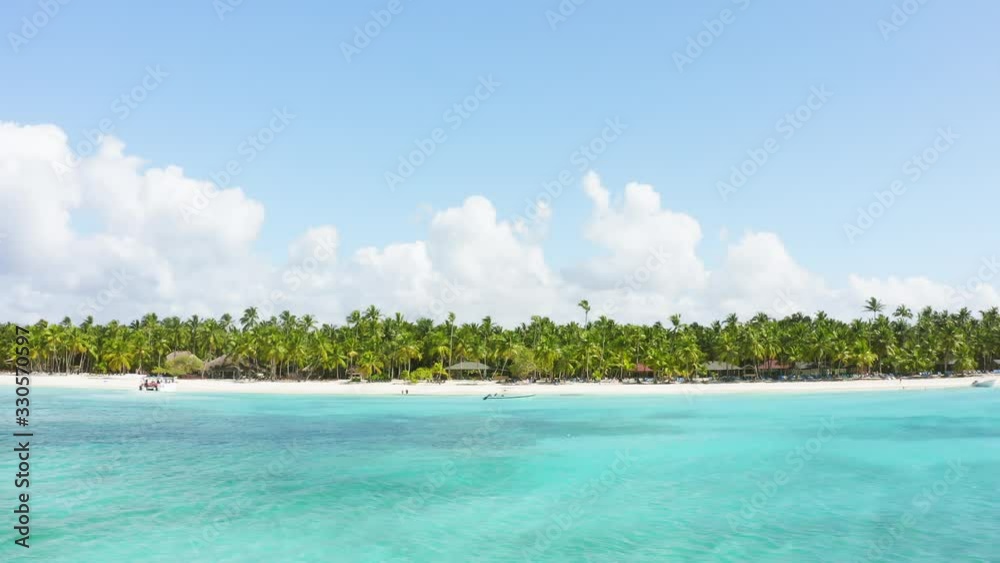 Sunny day on the Saona beach. Summer concept with tropical view on blue sea and sky and palm tree landscape. Paradise beach Sunny day on the Saona beach. Summer concept with tropical view on blue sea and sky and palm tree landscape. Paradise beach