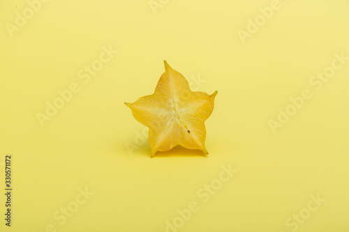 Bilde på lerret Star fruit carambola or starfruit with slice on yellow background
