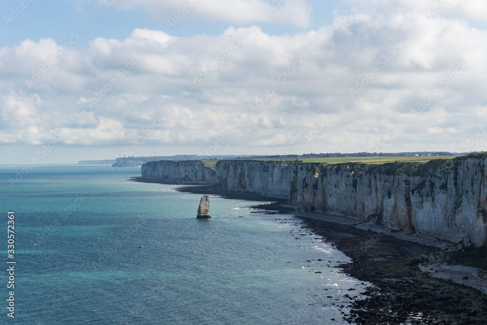 White chalk cliffs on the coast of the Atlantic Ocean and the English Channel. Scenic view of the coastline in Normandia in the town of Etretat in France. 