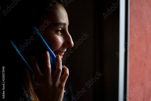 Woman talking on the phone at home.
