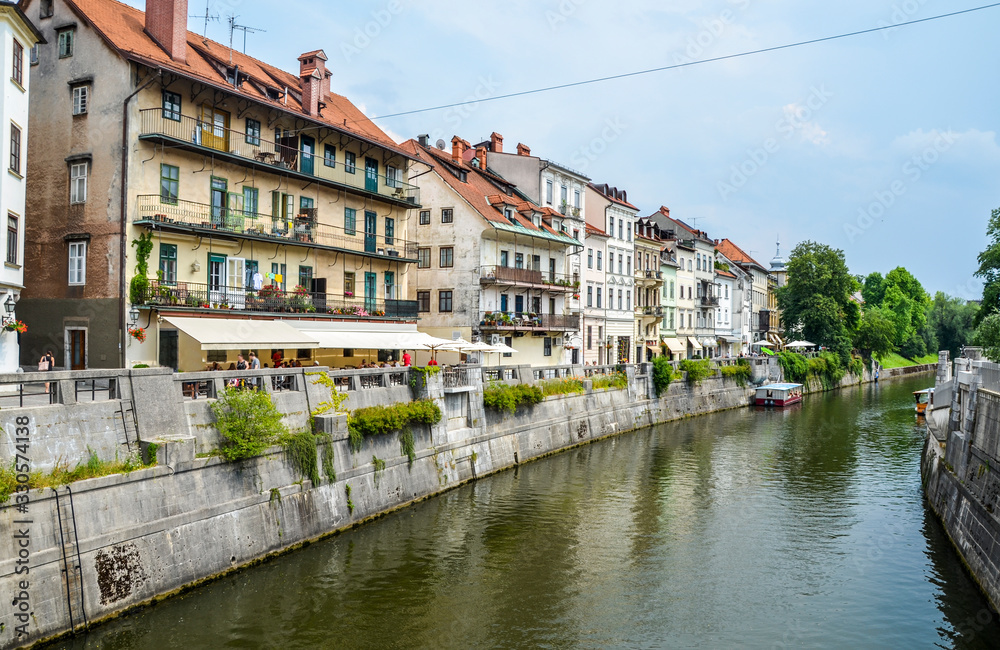 View on Ljubljanica river with old buildings in the historical center of Ljubljana. Ljubljana is the capital of Slovenia and famous european tourist destination.