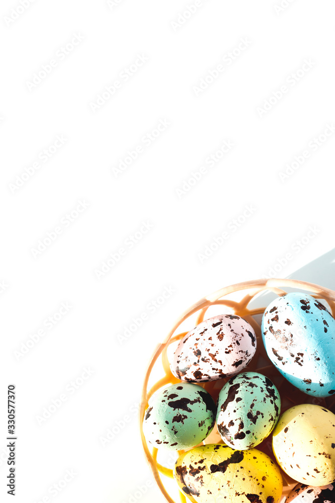 multicolored Easter eggs lie in a round basket. the view from the top. The concept of celebrating Easter
