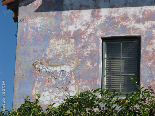 wall with window and peeling paint