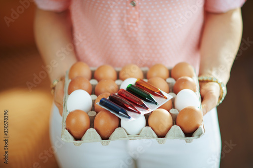 elegant female holding big egg carton box with food coloring photo