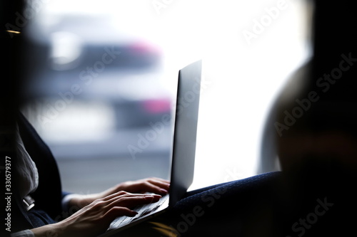 Business lady remotely working at a laptop close up