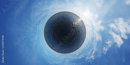 Foto Small planet covered by ocean on blue sky.