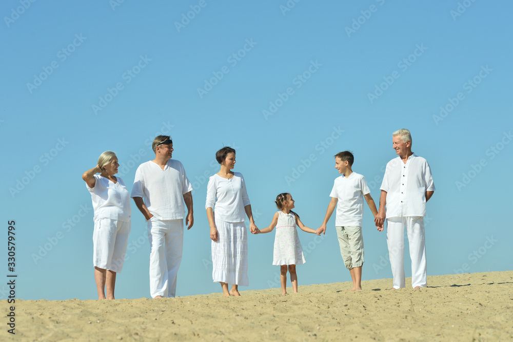 Portrait of happy family together on sand beach Portrait of happy family together on sand beach