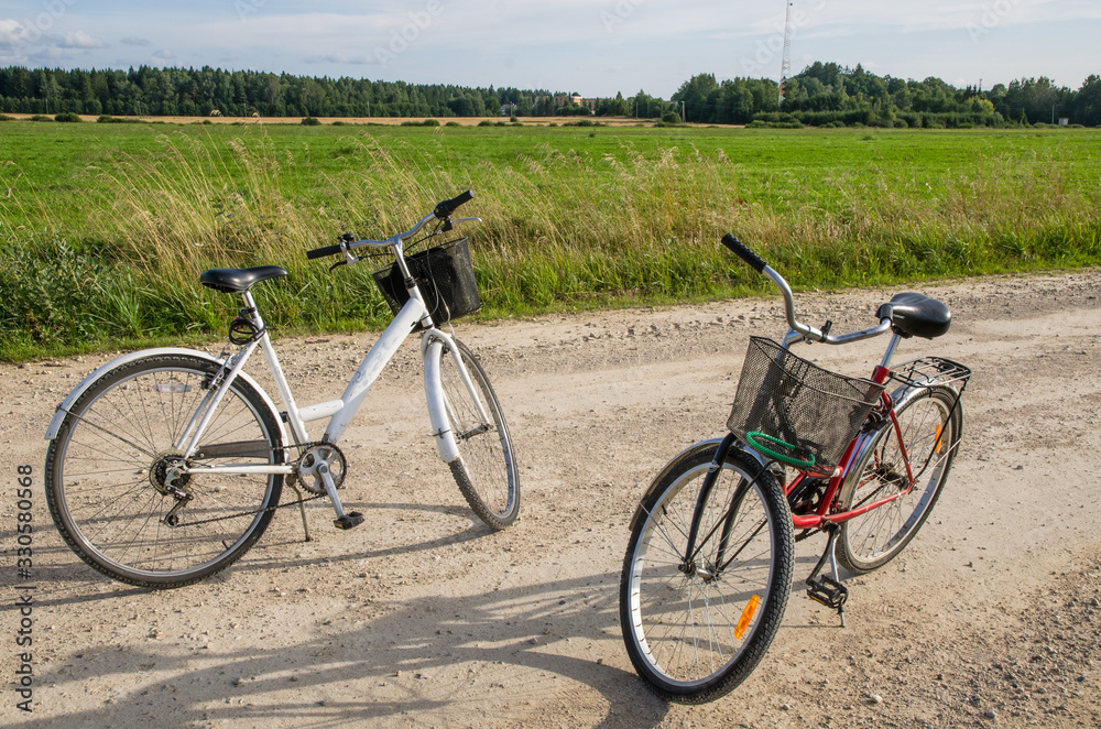 Two bicycles on a country road in summer. Photo taken in Jarvamaa, Estonia