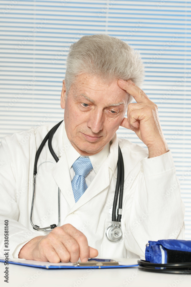 Portrait of sad senior male doctor posing Portrait of sad senior male doctor posing