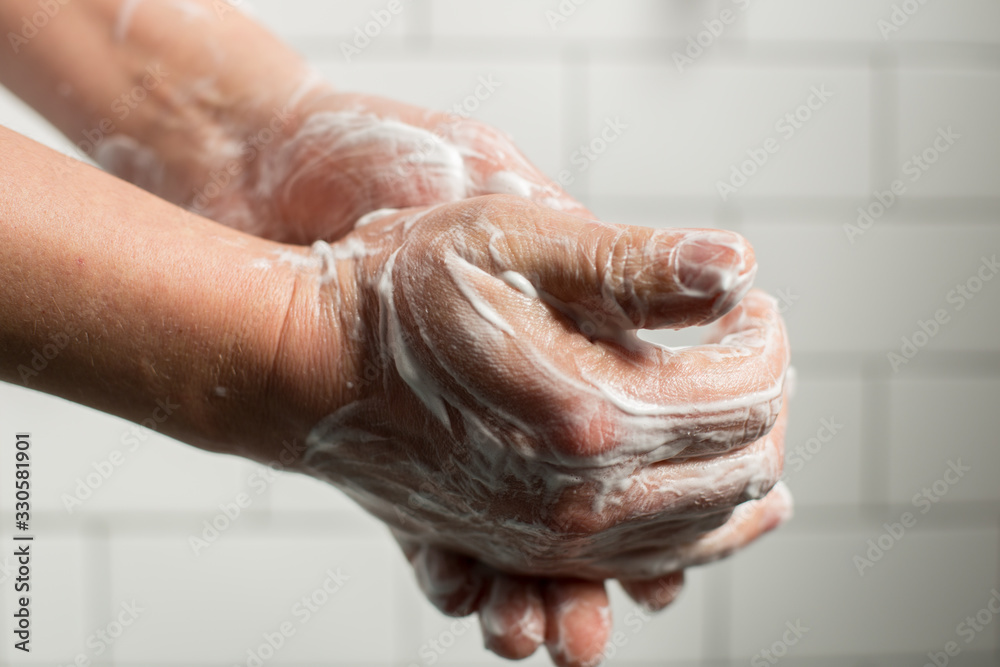 Fototapeta premium A man washing hands with soap. Preventing spreading virus concept.