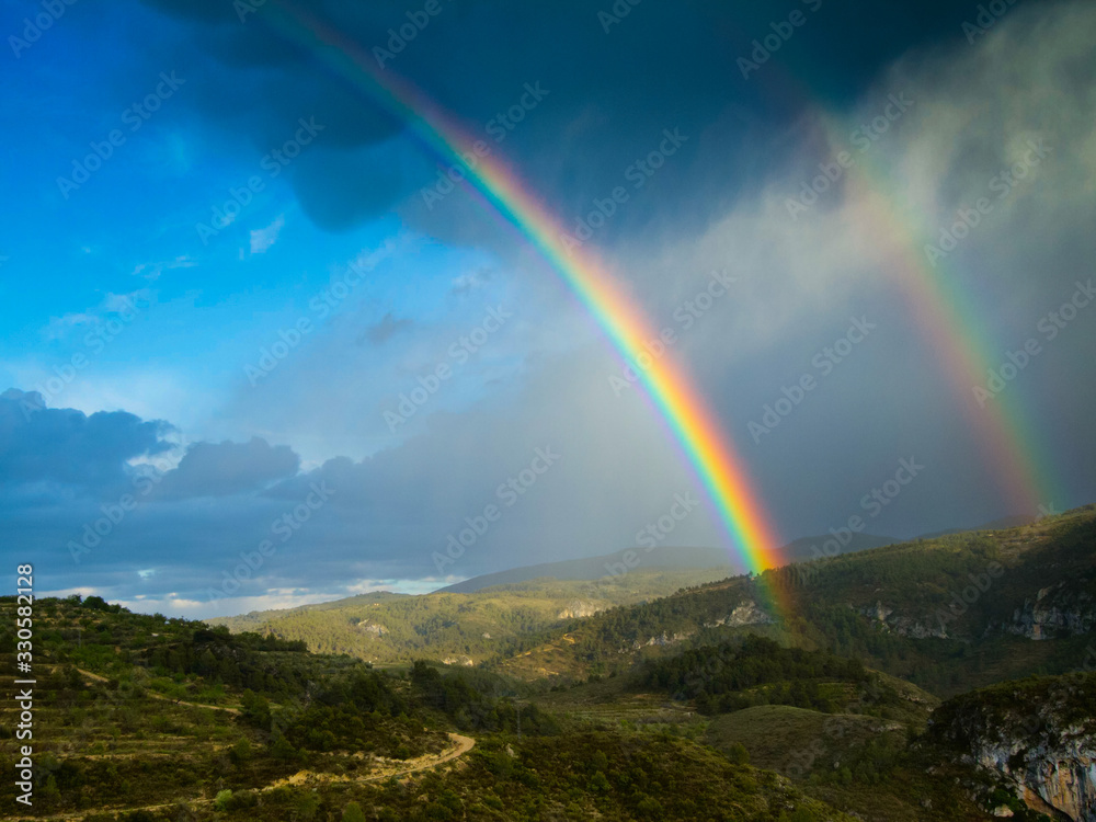 View of the mountains and a double rainbow.