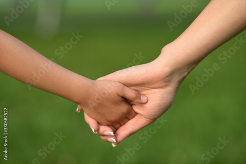 daughter and mother holding hands close up  © aletia2011