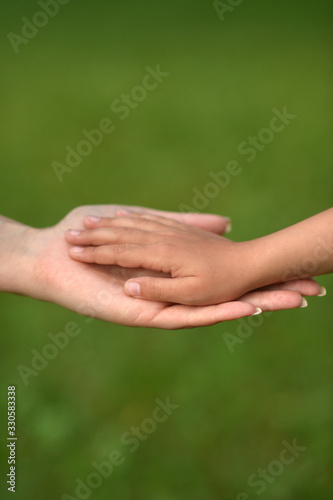 daughter and mother holding hands close up  © aletia2011
