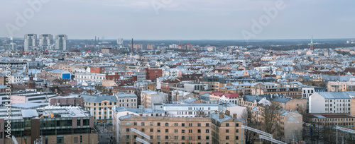 Panoramic, aerial view over Riga city. Scenic view over iconic church towers, old town and infrastructure.