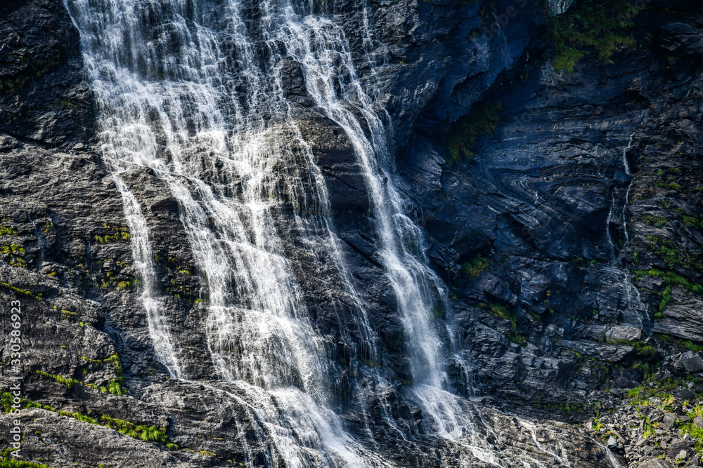 Panoramic beautiful deep forest waterfall in norway near blue ocean. Waterfalls mountain view close up. Panoramic beautiful deep forest waterfall in norway near blue ocean. Waterfalls mountain view close up.
