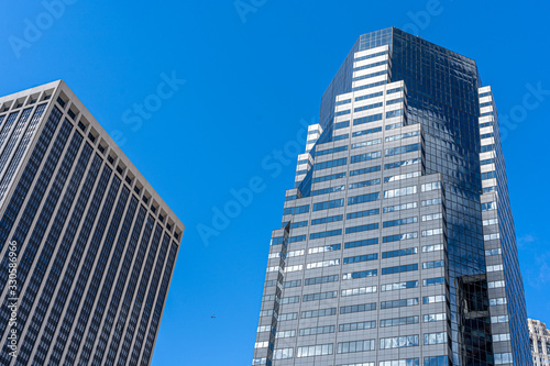 Reflections of the clouds on a glass skyscraper in new york city  scenic view from below