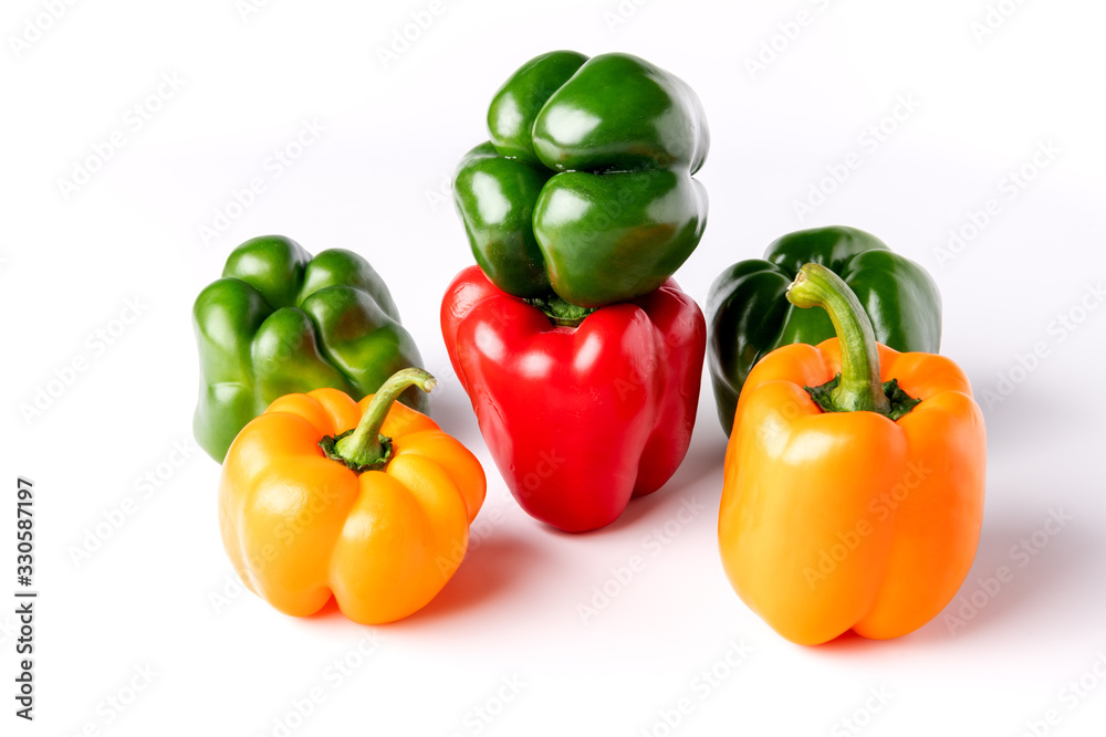 Varity of colored bell peppers on a white backdrop Varity of colored bell peppers on a white backdrop