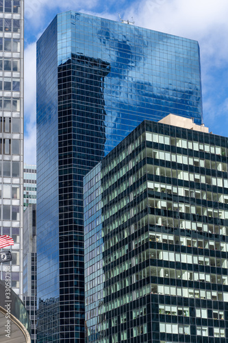 Reflections of the clouds on a glass skyscraper in new york city, scenic view from below