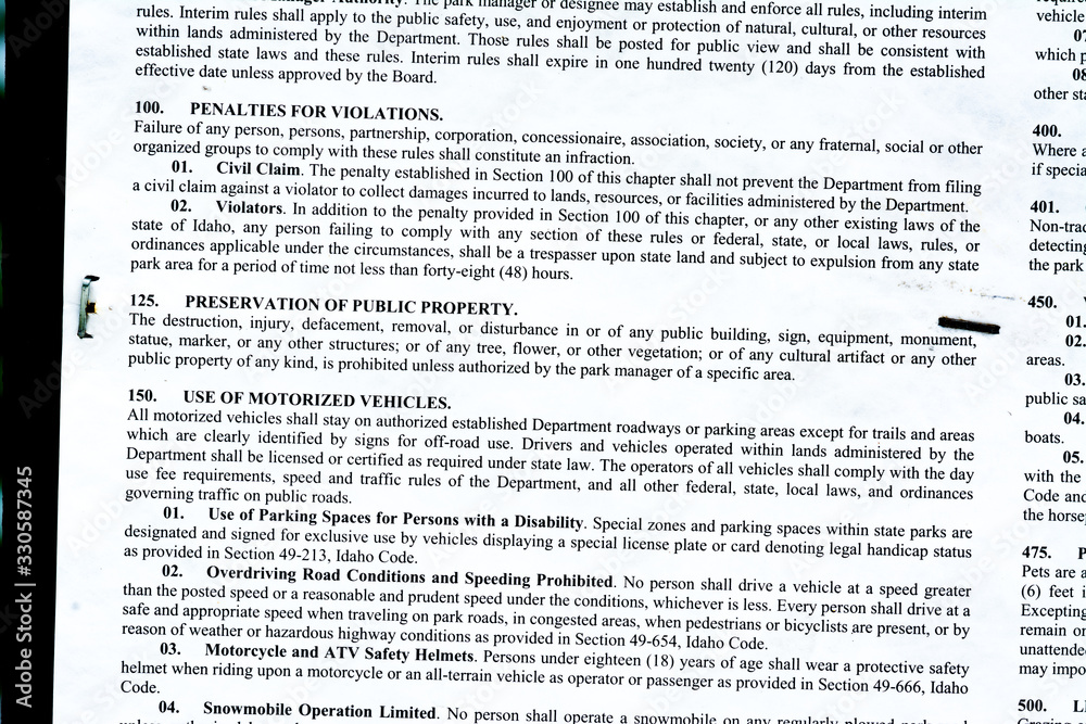 Portion of warning sign stapled to a post in the Idaho forest Portion of warning sign stapled to a post in the Idaho forest
