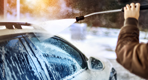 A man washing car using water jet. Wash luxury concept with Copy Space.