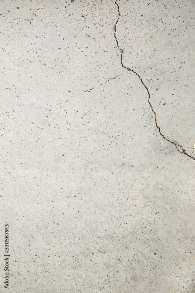 gray concrete slab with a crack in the corner gray concrete slab with a crack in the corner