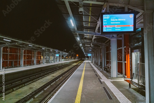 Train station at Gdansk airport GDN in Poland. railway platform of Lech Walesa Airport in Gdansk, Poland. Gdansk Airport lotnisko train station. Platform of Pomeranian Metropolitan Railway at night photo